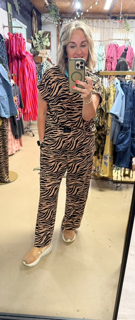 The model in the photo is wearing a small for 5’8”.  Model is 5’2”. She is also wearing a small, has pockets, small slits on the sides, 98% polyester, 2% spandex  is the material.